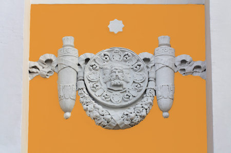 Fretwork in the form of an ancient family crest on the wall of a historic mansionの写真素材