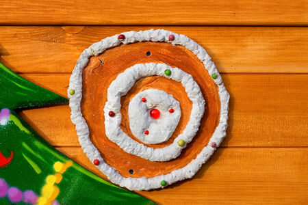 Decoration in the form of cake with cream and berries on the wooden wallの写真素材