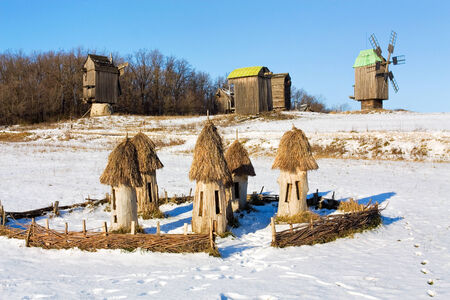 Ukrainian old time beehives on the background of a winter rural landscapeの写真素材