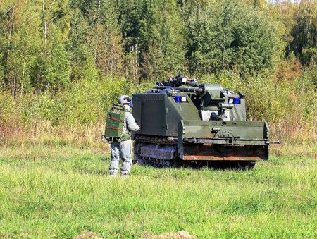 Self-propelled robot device and operator  in equipment with remote control going to  put out fire