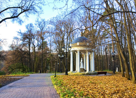 Arbour with a statue of the ancient goddess in the autumn parkの写真素材