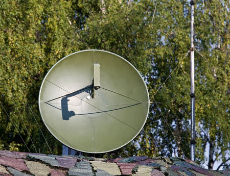 Dish antenna of military mobile device satellite communication with a metallic reflex reflector in operationのeditorial素材