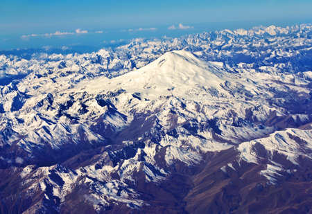 Top view of the Caucasus mountains with snow-covered bicapital top of Elbrusの写真素材