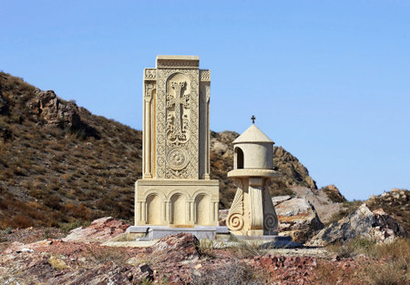 Ancient armenian tombstone on the background of a hill and blue sky
