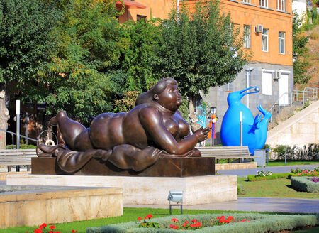 Sculpture of lying full woman with a cigarette in hand, made of metalのeditorial素材