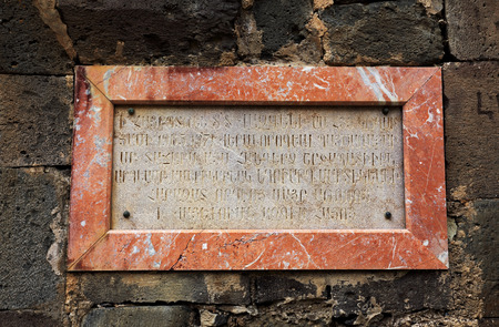 Ancient armenian inscription on the memorial plaque on the wall of the monasteryの写真素材
