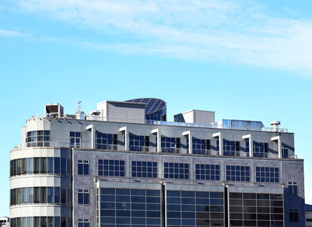 Ventilation pipes and actuators on the roof of an industrial building