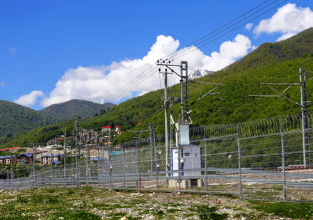 Railway with technical support facilities on the background hills