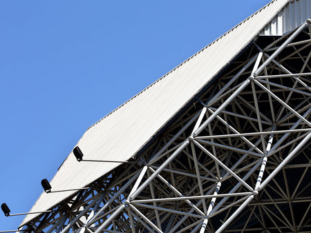 Reflective panel of the massive industrial building with lamps for lightingの写真素材