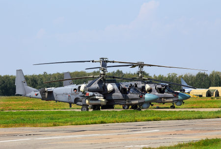 Modern russian attack helicopter Ka-52 with rockets, bombs, guns  on the parking placeat the air baseのeditorial素材