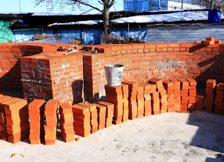 Construction materials and tools for laying a red brick wallの写真素材