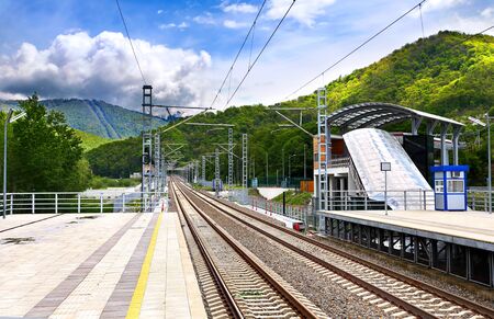 Railway with technical support facilities on the background hillsのeditorial素材
