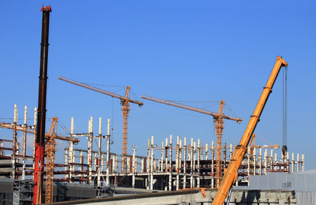 Cranes on the construction site of an industrial facility