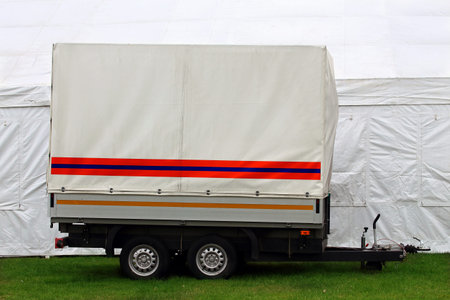 Two-axle trailer with  white tent