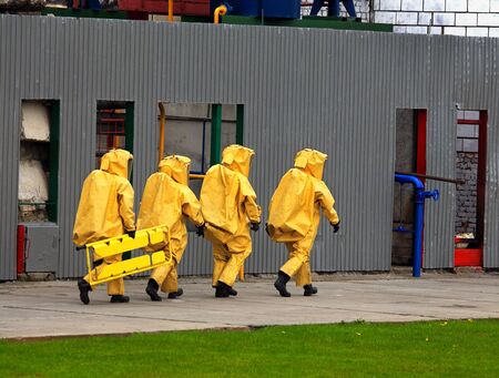 A group of four rescuers in the protective  clothing in the industrial accidentの写真素材