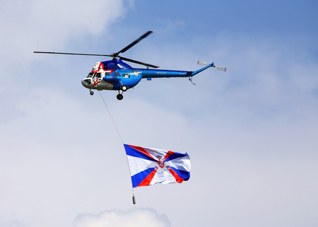 MOSCOW REGION ? JULY 27: Military transport helicopter with the flag of the Russian Federation at the opening of the military holiday on July 27, 2016 in Moscow regionのeditorial素材