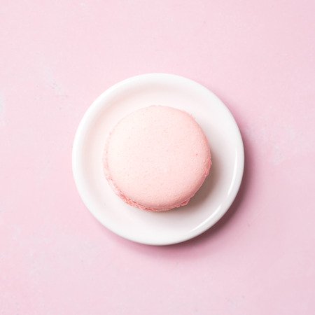 Top view of Pink colorful almond cookie cake on saucer on pastel backgroundの写真素材