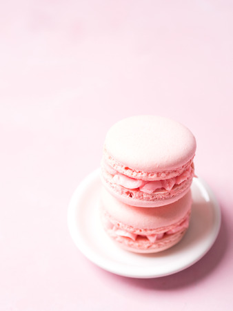 Pink colorful cake macaroon on pastel background, colorful almond cookiesの写真素材