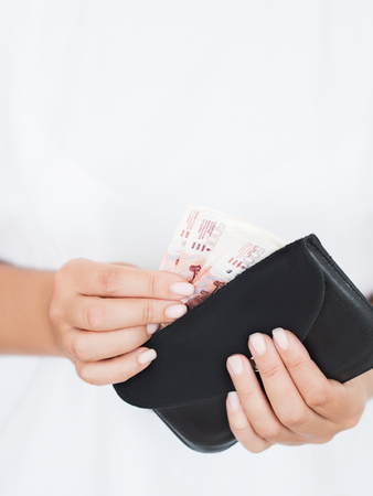 Close view of hands woman holding pile of rubles in walletの写真素材