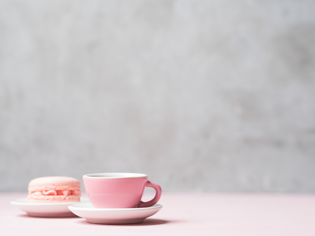 Still life with french delicious dessert macaroons and cup of coffee on pink background with copy space.の写真素材
