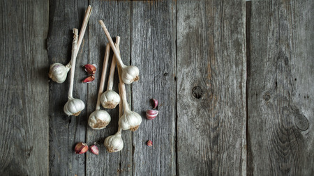 Bunch of garlic heads shot from above on wooden backgroundの写真素材