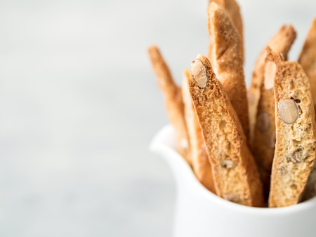 Biscotti (cantuccini) - traditional Italian almond dessert in white cup closeup.の写真素材