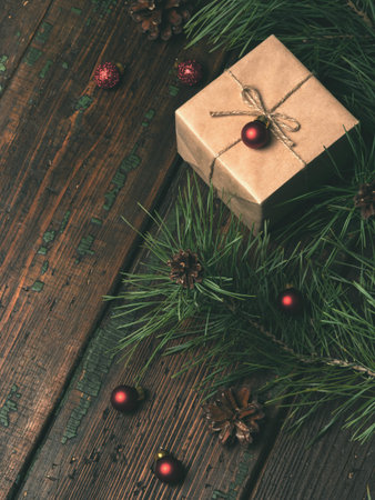 Christmas, New Year holiday background. Close view of gift box decorated craft paper and red glitter...