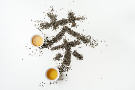 Traditional Chinese hanzi Calligraphy Tea stowed by tea on white fabric surface.
