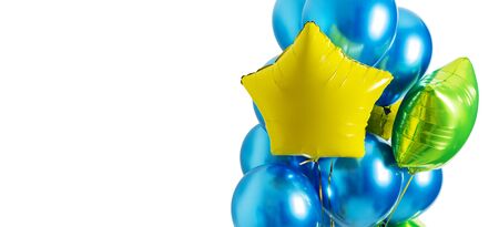 Set of blue and yellow, green foil helium balloons in form of stars on isolated white background with copy space. Concept of holiday, happy birthday.の写真素材