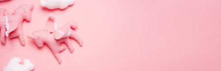 Close-up of felt toy unicorn from baby mobile on pink background with copy space. Preparation for...
