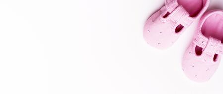 Baby textile Slippers for girl on pink background with copy space.の写真素材