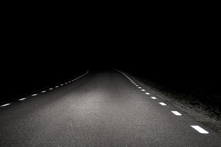 Rural asphalt road at nightの写真素材