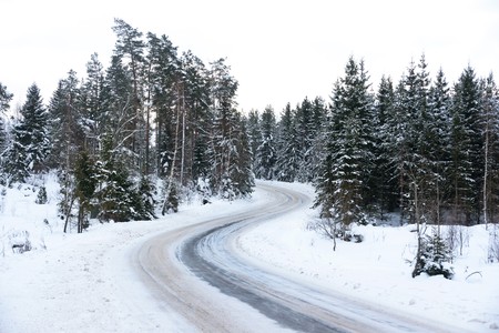 Winding country road in winterの写真素材