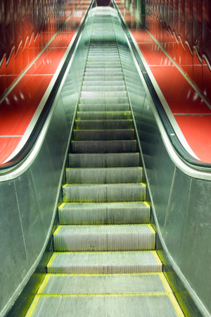 Escalators and red tiles with diminishing perspective