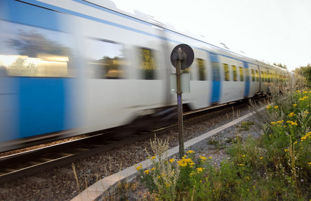 Commuter train at full speed in a rural area