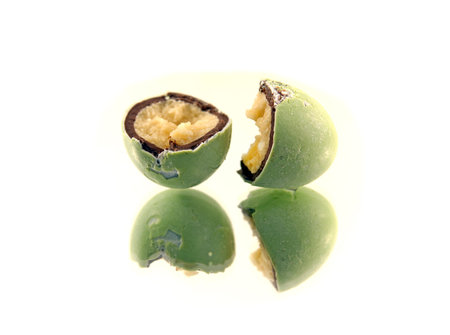 Close up of broken green marzipan easter egg isolatd on whiteの写真素材