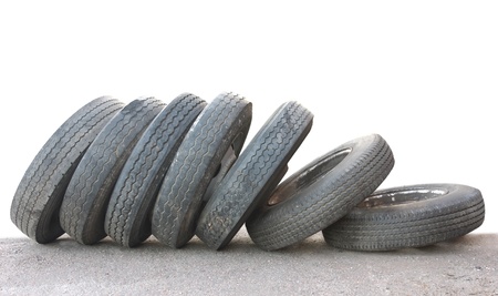 A row of old obsolete tires isolated on whiteの写真素材