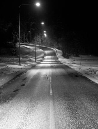 Empty winter road at nightの写真素材