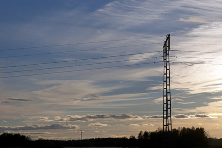 Electricity pylon against blue evening sky 