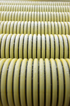 Close up of pile of yellow plastic pipes with ice crystalsの写真素材