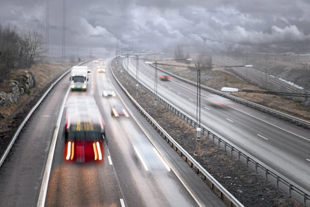 Traffic on highway on a foggy rainy day