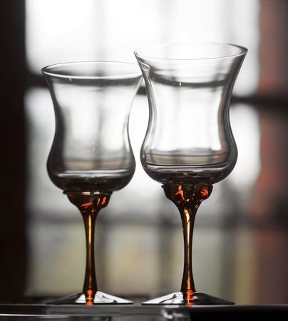 Two crystal wine glasses in front of a windowの写真素材