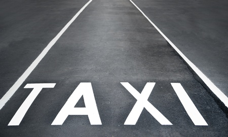 taxi lane, white text on asphaltの写真素材