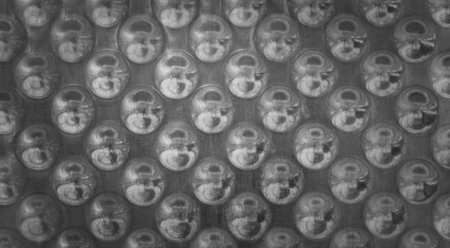 Abstract metal background with regular circular patternの写真素材