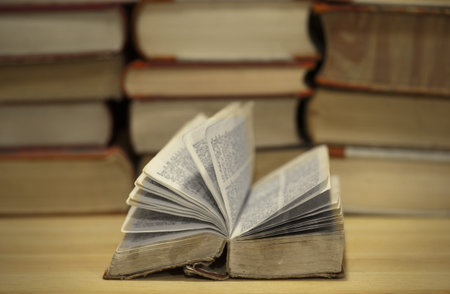 Vintage book on desk with other books in background