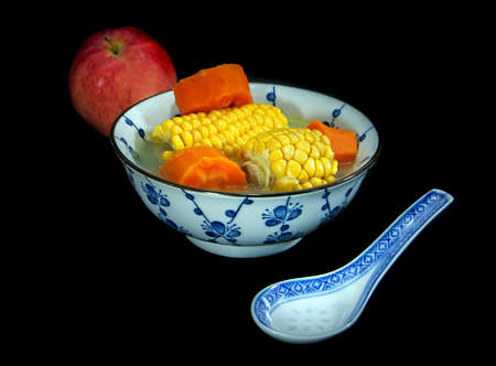 Chinese autumn chicken soup with vegetables, isolated on blackの写真素材