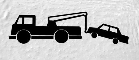 Sign wth car being towed away by a truckの写真素材