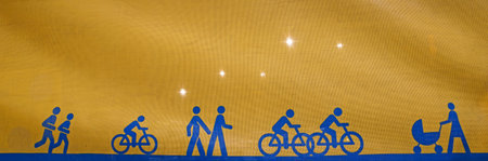 Back lit yellow canvas with blue symbolic cyclists and pedestrians, directing people how to get round a building siteの写真素材
