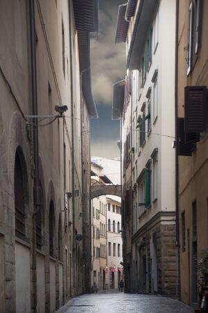 Narrow street in Florence, Italy, on a cloudy rainy day Narrow street in Florence, Italy, on a cloudy rainy day
