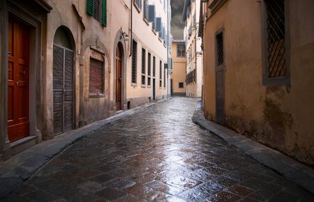 Narrow street in Florence on a rainy dayの写真素材